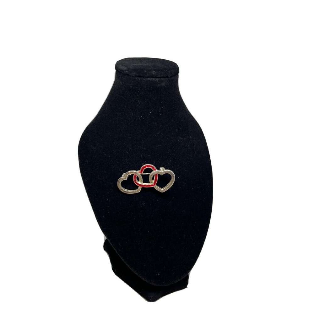 cute little brooch with 3 hearts and one red heart in the middle
